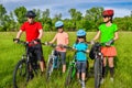 Family on bikes cycling outdoors, active healthy parents and kids riding bicycles, family sport and fitness Royalty Free Stock Photo