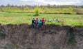 Family on bikes cycling outdoors, active parents and kids on bicycles, aerial view of happy family with children relaxing on grass Royalty Free Stock Photo