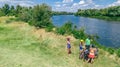 Family on bikes cycling outdoors, active parents and kids on bicycles, aerial view of happy family with children relaxing Royalty Free Stock Photo