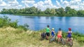 Family on bikes cycling outdoors, active parents and kids on bicycles, aerial view of happy family with children relaxing Royalty Free Stock Photo