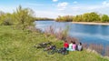 Family on bikes cycling outdoors, active parents and kids on bicycles, aerial view of happy family with children relaxing