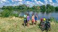 Family on bikes cycling outdoors, active parents and kids on bicycles, aerial view of happy family with children relaxing Royalty Free Stock Photo