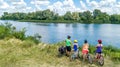 Family on bikes cycling outdoors, active parents and kids on bicycles, aerial view of happy family with children relaxing Royalty Free Stock Photo