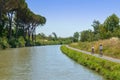 Family on bikes, mother and daughter cycling by canal du Midi, summer vacation in France Royalty Free Stock Photo