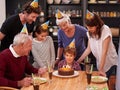 Family, birthday cake and restaurant with boy, parents and grandparents together with fun and candles. Happy, smile and Royalty Free Stock Photo