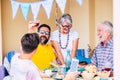 Family birthday. People toasting red wine. Wood table with natural meal. Senior grandparents Royalty Free Stock Photo