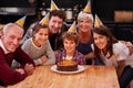 Family, birthday and portrait with boy, parents and grandparents together with cake and candles. Happy, smile and Royalty Free Stock Photo