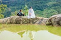 A family of the Black H'mong Ethnic Minority People sit on hill in Sapa, Vietnam on September 14, 2016 Royalty Free Stock Photo