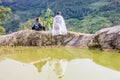 A family of the Black H'mong Ethnic Minority People sit on hill in Sapa, Vietnam on September 14, 2016