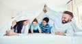 Family, blanket and fun by children and parents in bed, happy and smile while playing and bonding in their home. Bedroom Royalty Free Stock Photo