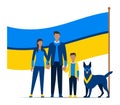 Family in blue and yellow clothing with dog standing before large flag. Patriotic family portrait with pet, unity and