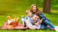 Family bonding. Cute boy with mom and dad on summer picnic in countryside, empty space Royalty Free Stock Photo