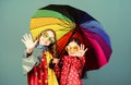 Family bonds. Small girls in raincoat. autumn fashion. cheerful hipster children, sisterhood. rain protection. Rainbow