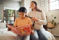 Family, book or education and a girl reading in a bedroom with her mom playing with her hair in their home. Books Royalty Free Stock Photo