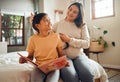 Family, book or learning and a girl reading in a bedroom with her mom playing with her hair in their home. Books Royalty Free Stock Photo