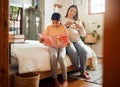 Family, books or education and a girl reading in a bedroom with her mom playing with her hair in their home. Book Royalty Free Stock Photo