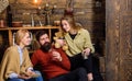 Family of bookworms reading together on couch. Parents and teenage daughter spending Christmas in countryside. Bearded Royalty Free Stock Photo