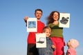 Family with boy and baby with wishes cards