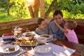 Family Breakfast in a country house. children happily cuddling with daddy