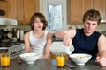 Family breakfast fun - teen brothers having cereal: candid shots