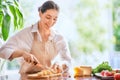 Woman is cutting bread and cheese