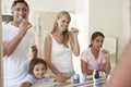 Family Brushing Teeth In Bathroom Mirror Royalty Free Stock Photo