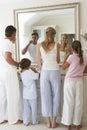 Family Brushing Teeth In Bathroom Mirror Royalty Free Stock Photo