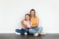 Family Budget. Smiling Beautiful Mother And Little Daughter Holding Piggy Bank Royalty Free Stock Photo