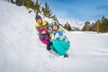 Family build a small snowman next to ski slope. Winter holidays in Andorra