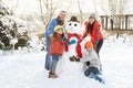 Family Building Snowman In Garden Royalty Free Stock Photo