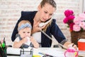 Family Business - telecommute Businesswoman and mother with kid is making a phone call Royalty Free Stock Photo