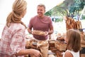 Family Buying Bread From Bakery Stall At Farmers Market