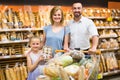 Family buying bread in food store. Royalty Free Stock Photo