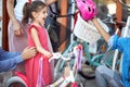 Family buying helmet for bicycle for a girl in a bicycle store Royalty Free Stock Photo