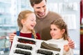 Family buying model railroad in toy store Royalty Free Stock Photo