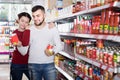 Family buying tinned food at supermarket Royalty Free Stock Photo