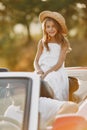 Family in a cabriolet convertible car at the sunset Royalty Free Stock Photo