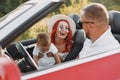 Family in a cabriolet convertible car at the sunset Royalty Free Stock Photo