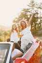 Family in a cabriolet convertible car at the sunset Royalty Free Stock Photo