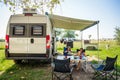 Family camping with a campervan in campsites in Greece or Croatia Royalty Free Stock Photo