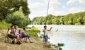 Family camping and fishing, river and forest, summer season Royalty Free Stock Photo