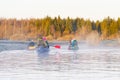 family canoeing on the river in the early morning. joint pastime, entertainment, outdoor recreation, acquaintance with