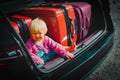 Family car travel - cute little baby and suitcases packed