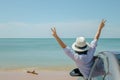 Family car trip at the sea, Asian woman feeling happiness and she raising hers hands up over head, she looking to seascape view. Royalty Free Stock Photo