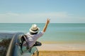 Family car trip at the sea, Asian woman feeling happiness and she raising hers hands up over head, she looking to seascape view. Royalty Free Stock Photo