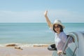 Family car trip at the sea, Asian woman feeling happiness and she raising hers hands up over head. Royalty Free Stock Photo