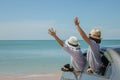 Family car trip at the sea, Woman and child cheerful raising their hands up and feeling happiness. Royalty Free Stock Photo