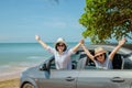 Family car trip at the sea, Woman and child cheerful raising their hands up and feeling happiness.