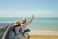 Family car trip at the sea, Woman and child cheerful raising their hands up and feeling happiness. Royalty Free Stock Photo