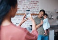 Family, care and mother with phone for photo of father and baby with down syndrome in the living room of their house Royalty Free Stock Photo